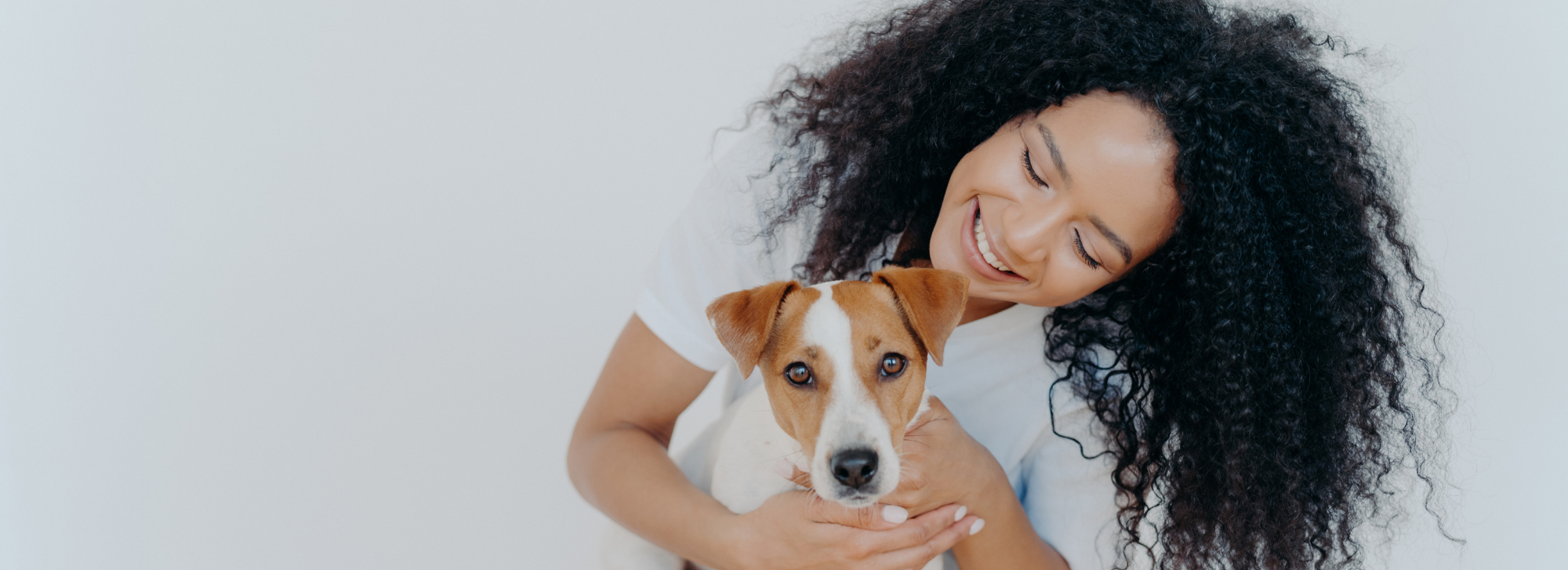 A person hugging their dog.