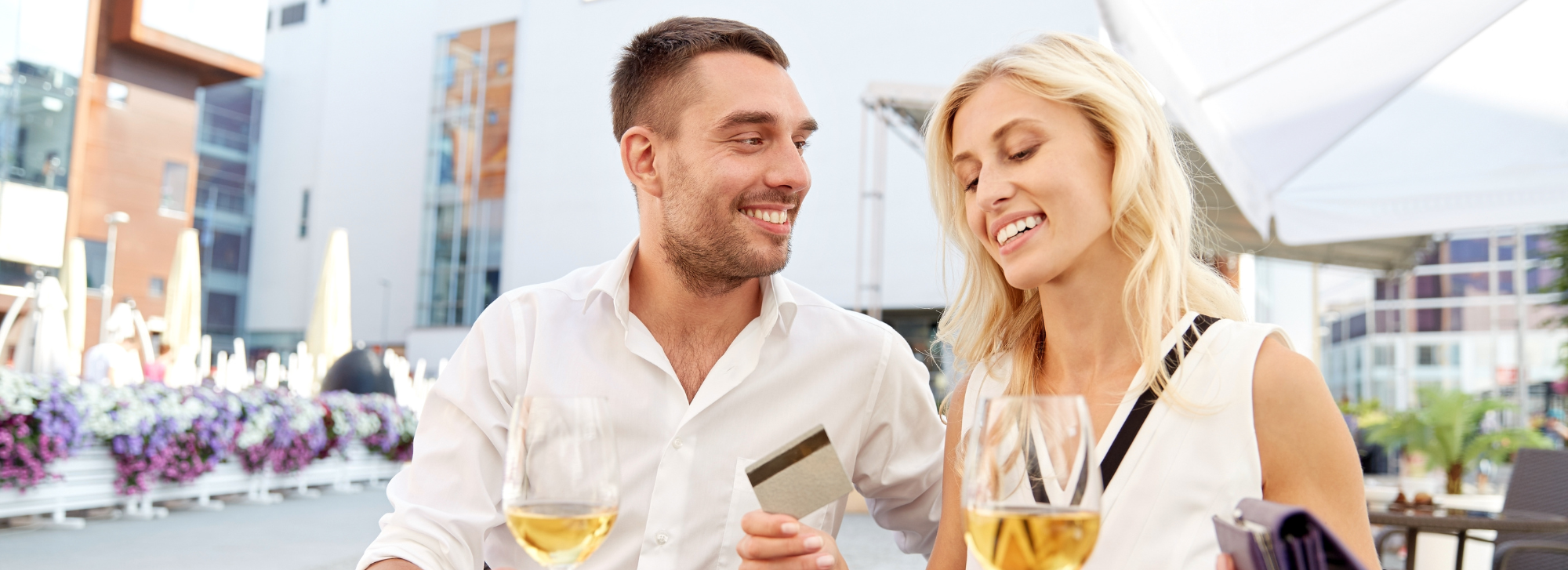 A couple paying for their meal and drinks on a vacation.