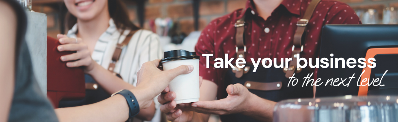 A customer receiving a cup of coffee from a barista.  