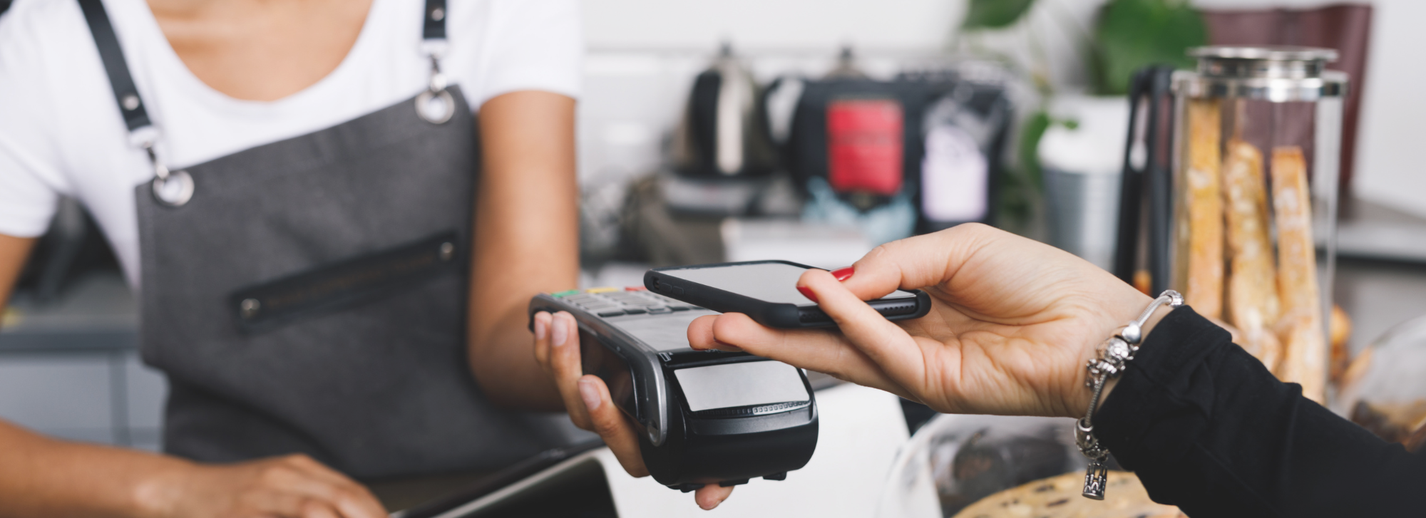 Someone is paying the cashier off of their phone via the tap feature.