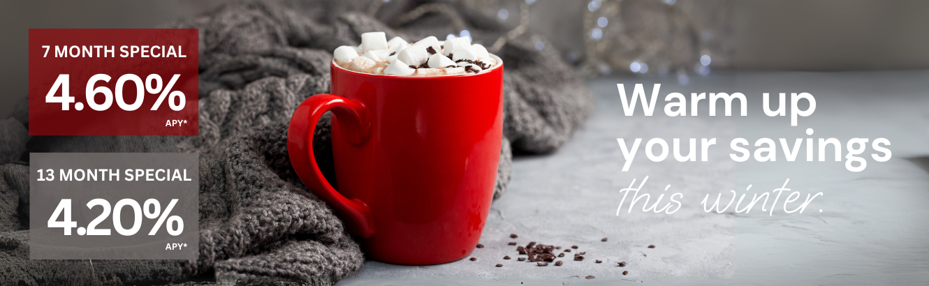 Gray blanket and a red cup of hot chocolate